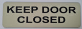Almond sign with Black text 'KEEP DOOR CLOSED' text on a white background