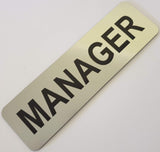 Silver acrylic nameplate with Black text 'MANAGER'