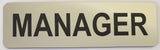 Silver acrylic sign with Black text 'MANAGER'