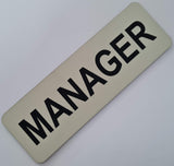Almond acrylic  nameplate with Black text 'MANAGER'