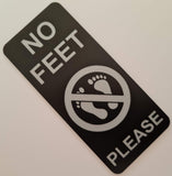 Black acrylic sign with 'No Feet Please' text and symbol  engraved in a silver colour