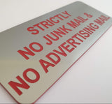 Mailbox Silver acrylic sign with red engraved text 'Strictly No Junk Mail & Advertising Mail' on a beige background