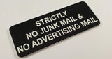 Black acrylic sign with white engraved text 'Strictly No Junk Mail & Advertising Mail' on a light gray background