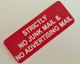 Red acrylic sign with white engraved text