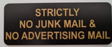 Black sign with gold engraved text 'Strictly No Junk Mail & No Advertising Mail' on a white background