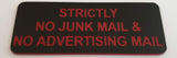 Black acrylic sign with red engraved text 'Strictly No Junk Mail & No Advertising Mail' on a white background