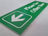 Bright Green acrylic sign with white engraved text and arrow on a white background