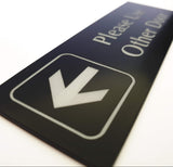 Black acrylic sign with Silver engraved arrow and text on a white background