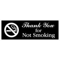 Sign with 'Thank You for Not Smoking' text and no smoking symbol on a black background