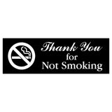 Sign with 'Thank You for Not Smoking' text and no smoking symbol on a black background