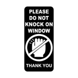 Sign with text 'Please do not knock on window' and a hand icon crossed out.