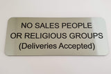 Silver acrylic sign with black engraved text 'NO SALES PEOPLE OR RELIGIOUS GROUPS (Deliveries Accepted)' on a white background