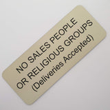 Almond acrylic sign with black engraved text on a white background