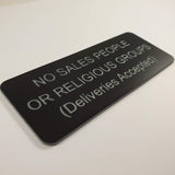 Matte Black acrylic sign with silver engraved text on a white background