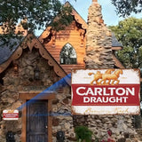 Vintage Carlton Draught sign on a stone building with wooden roof