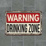 Vintage-style warning sign with 'WARNING DRINKING ZONE' text on a gray tiled background
