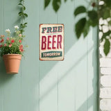 Vintage-style 'Free Beer Tomorrow' sign on a light green wall with plants.
