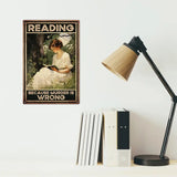 Metal Sign with a woman reading and text 'Reading because murder is wrong' on a wall above books and a lamp.