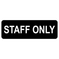 A black acrylic sign with the text 'STAFF ONLY' engraved in white.